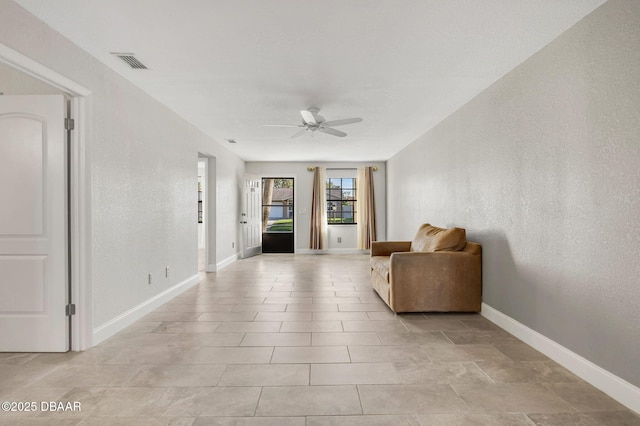 unfurnished room featuring visible vents, ceiling fan, baseboards, and light tile patterned flooring