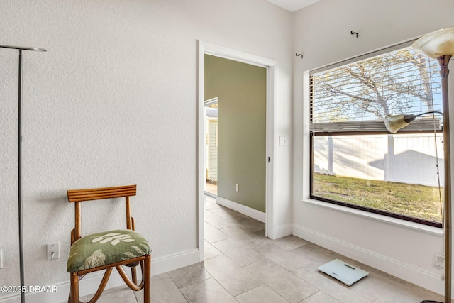 interior space featuring light tile patterned floors and baseboards