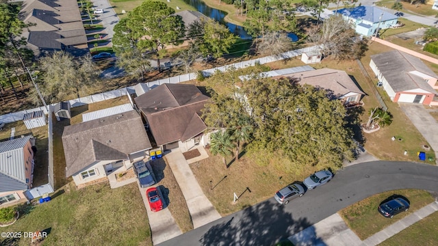 drone / aerial view featuring a residential view and a water view