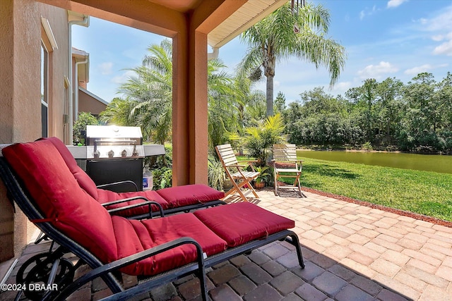 view of patio / terrace featuring grilling area and a water view