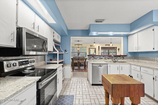 kitchen featuring white cabinetry, visible vents, appliances with stainless steel finishes, and a sink