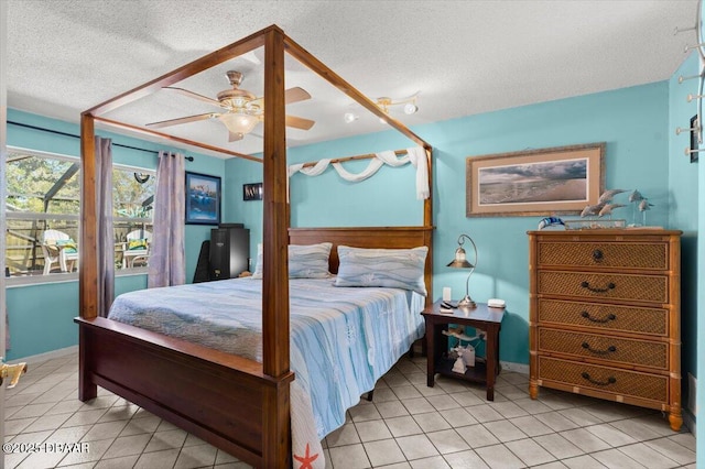 bedroom featuring light tile patterned floors, baseboards, a textured ceiling, and a ceiling fan