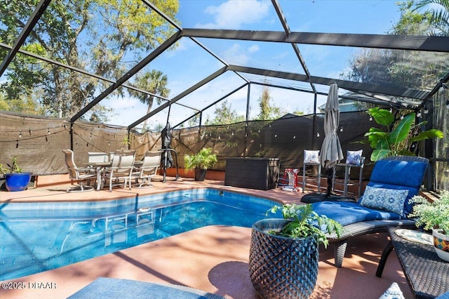 pool with glass enclosure, a patio, and fence