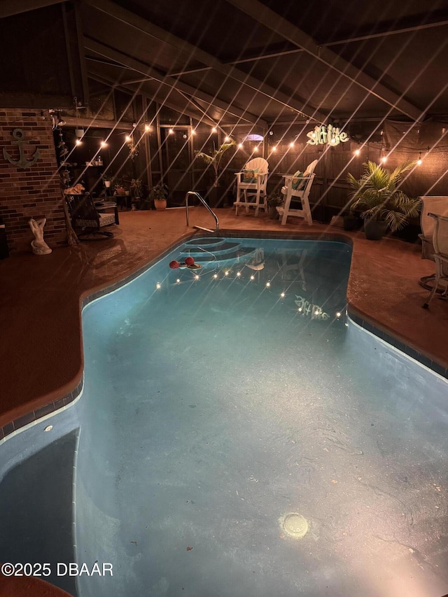 view of swimming pool with fence and a patio