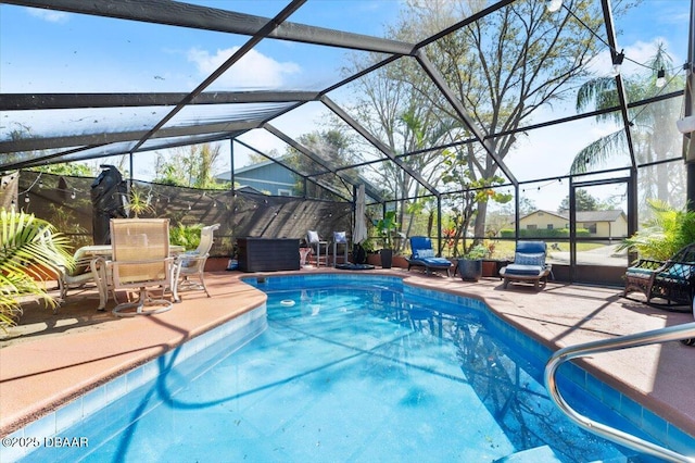 outdoor pool with glass enclosure and a patio area