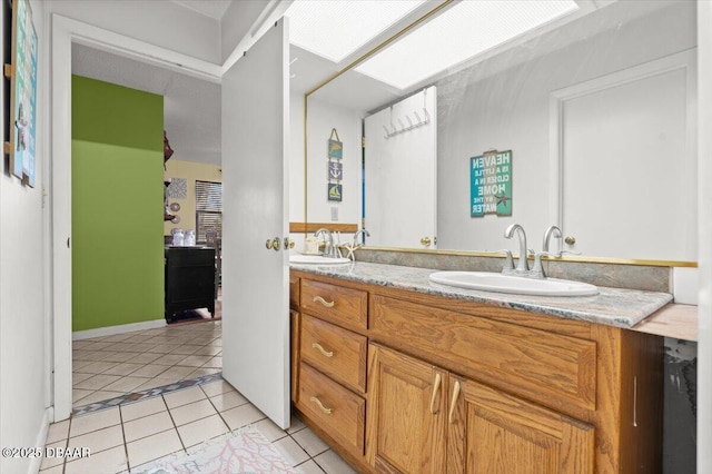 full bath with tile patterned floors, double vanity, and a sink