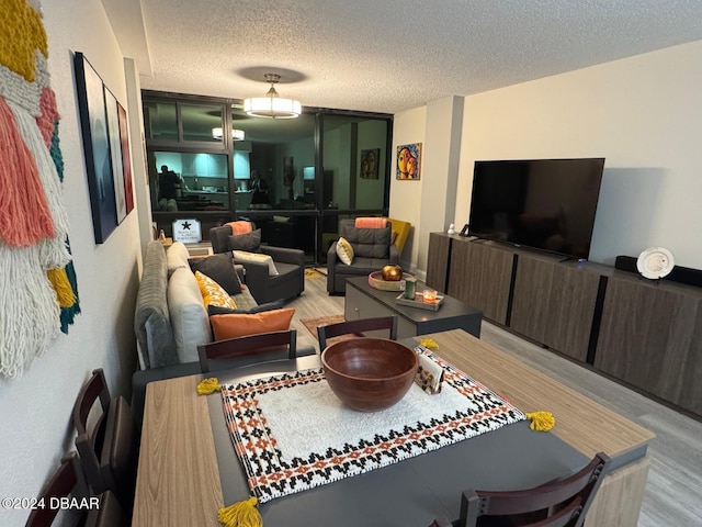 living room featuring a textured ceiling and light wood-type flooring