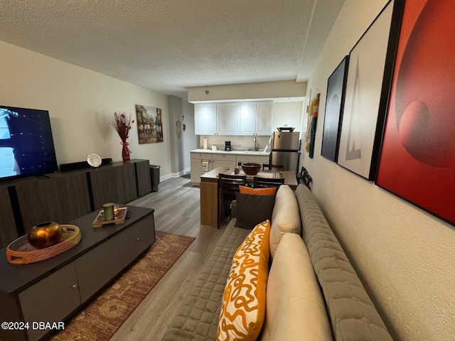 living room featuring dark hardwood / wood-style floors and a textured ceiling