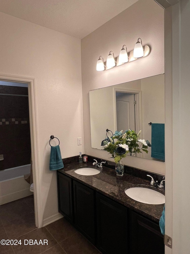 bathroom with tile patterned flooring, vanity, and toilet