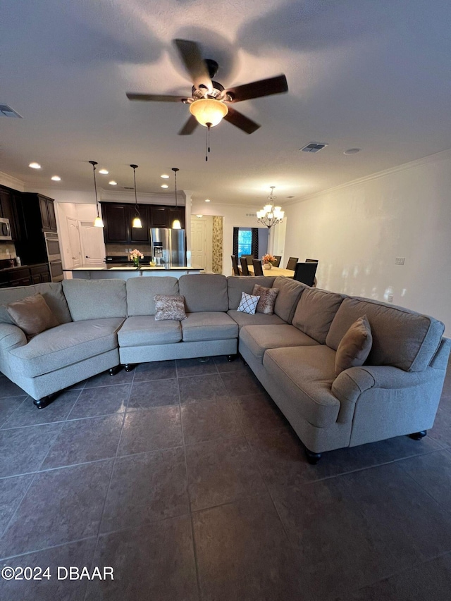 living room with crown molding, dark tile patterned floors, and ceiling fan with notable chandelier