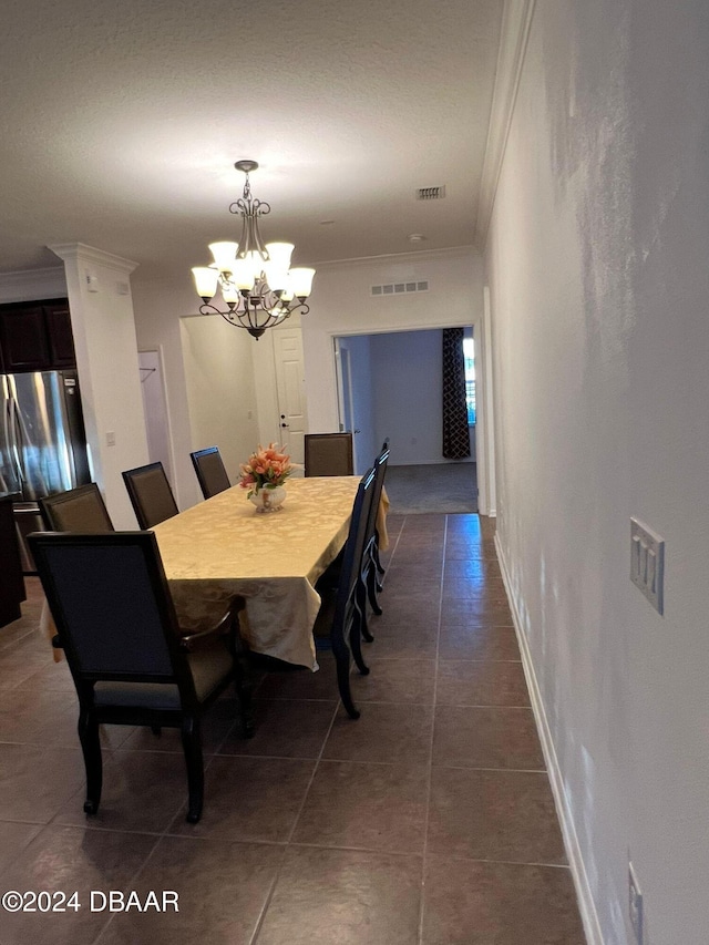 tiled dining space with crown molding and an inviting chandelier