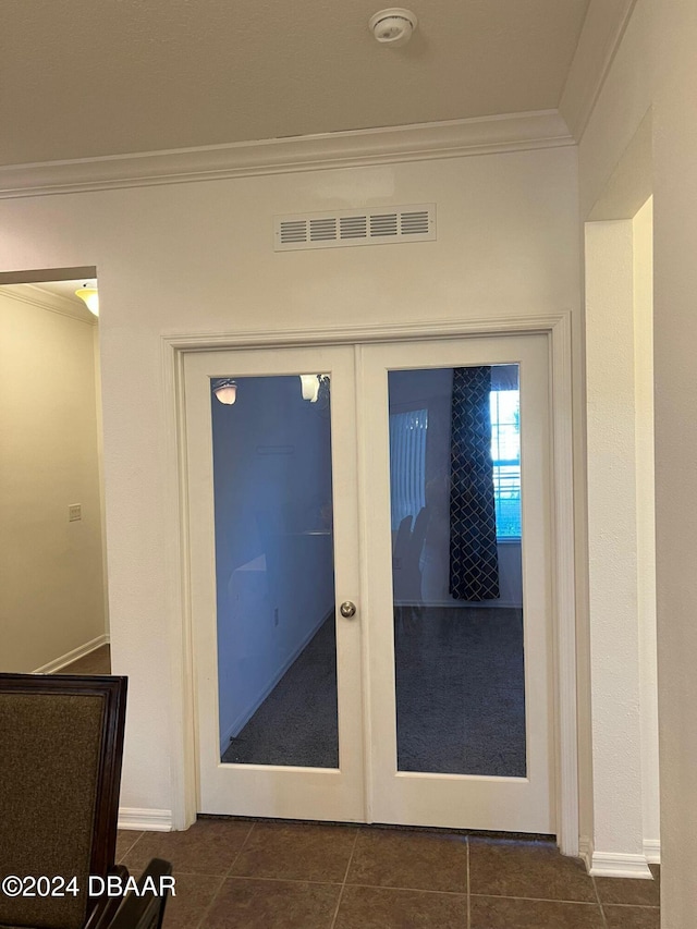 interior details featuring tile patterned floors, french doors, and ornamental molding