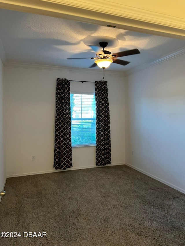 carpeted spare room with ceiling fan, a textured ceiling, and ornamental molding