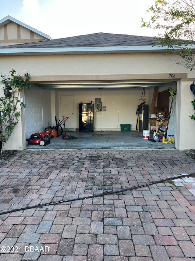 garage featuring electric water heater and electric panel