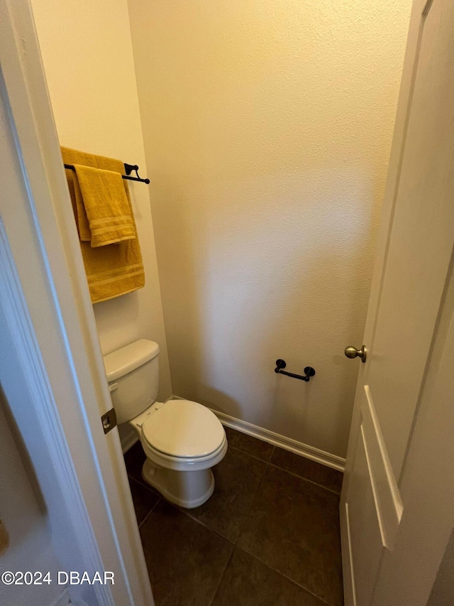 bathroom with tile patterned flooring and toilet