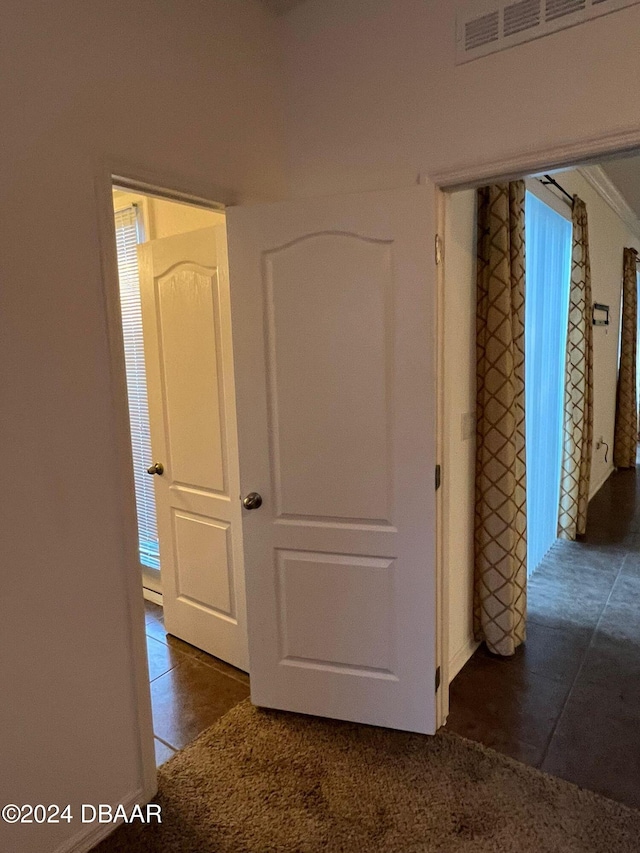 corridor with dark tile patterned floors