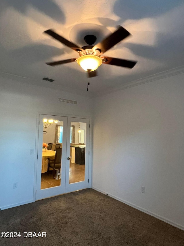 spare room with ceiling fan, french doors, carpet floors, and ornamental molding