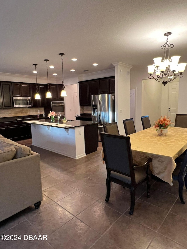 tiled dining space with a notable chandelier and ornamental molding