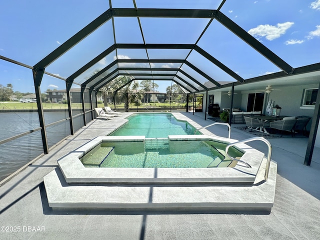 view of pool featuring ceiling fan, a pool with connected hot tub, a patio area, and outdoor lounge area