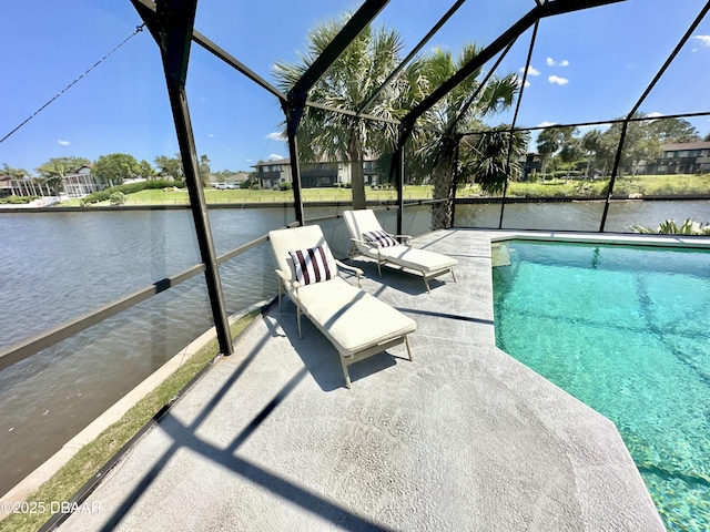 pool with glass enclosure, a patio, and a water view