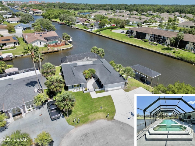 bird's eye view featuring a water view and a residential view