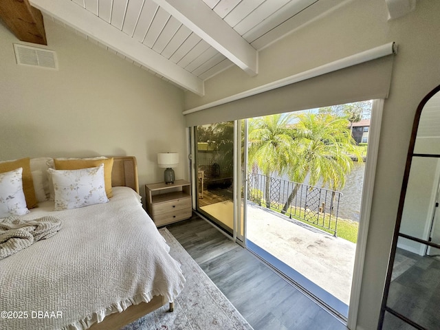 bedroom with visible vents, access to exterior, wood finished floors, and multiple windows