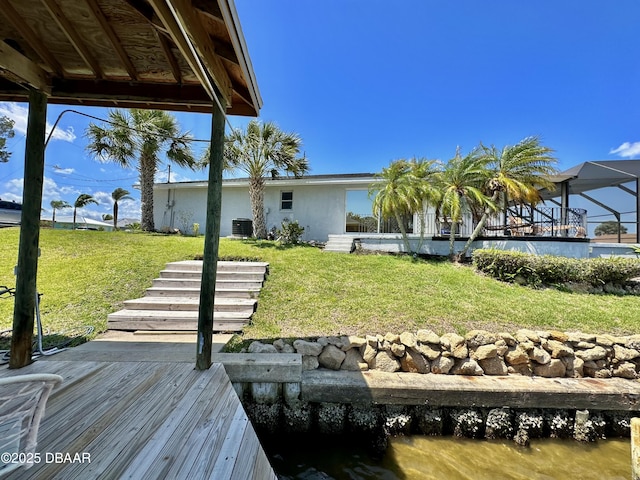 dock area featuring central AC and a yard
