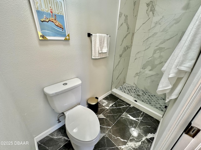 full bath with baseboards, toilet, a marble finish shower, and marble finish floor