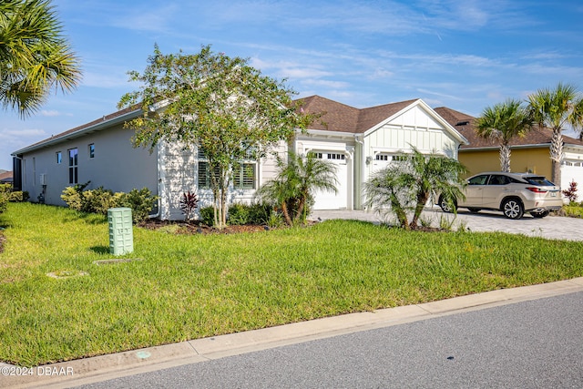 view of front of property with a garage and a front yard