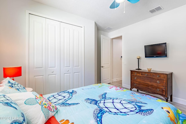 1078 Castaway Ct, Daytona Beach, FL 32124 - bedroom with a closet, baseboards, wood finished floors, and a ceiling fan