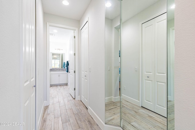 hallway with light hardwood / wood-style floors