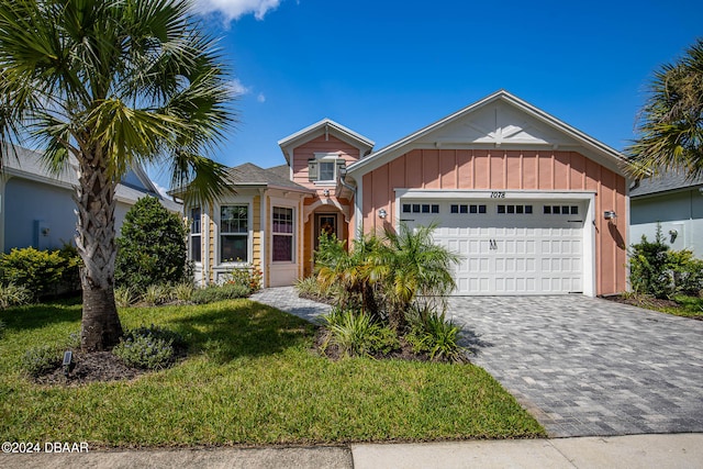 view of front of house with a garage and a front yard