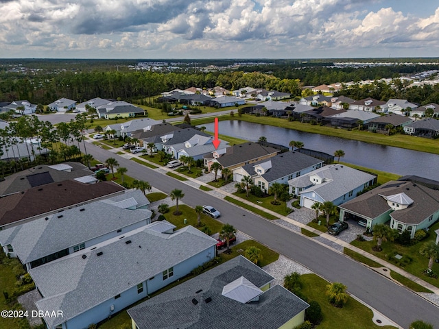 birds eye view of property with a water view