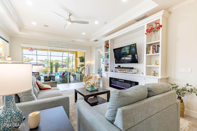 1078 Castaway Ct, Daytona Beach, FL 32124 - living area with ceiling fan, wood finished floors, ornamental molding, a tray ceiling, and recessed lighting