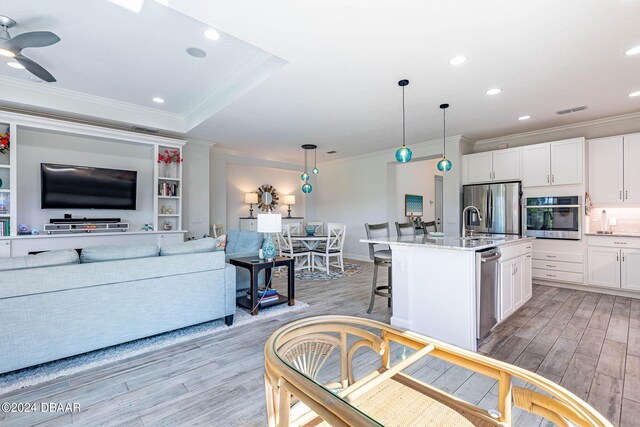 1078 Castaway Ct, Daytona Beach, FL 32124 - living room featuring light wood-style floors, ornamental molding, recessed lighting, a ceiling fan, and baseboards