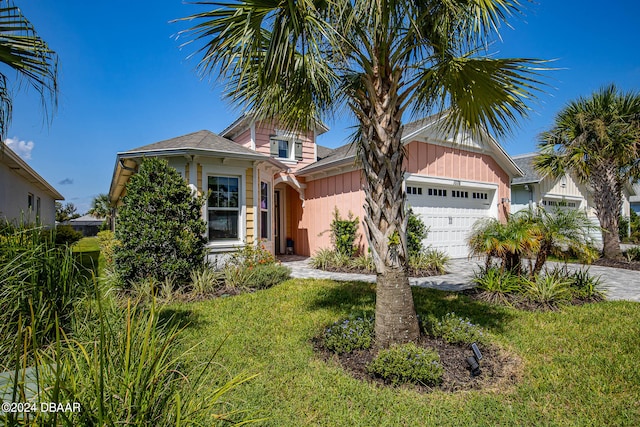 view of front facade featuring a garage and a front lawn