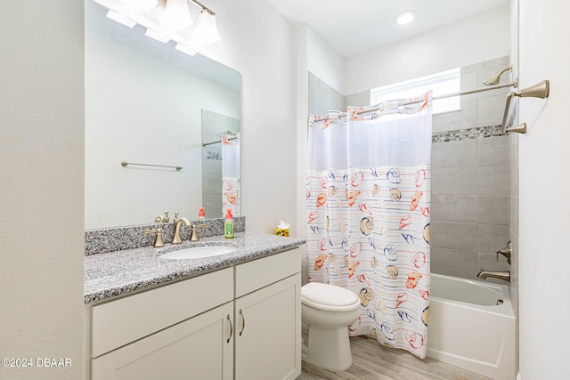 full bathroom with wood-type flooring, vanity, toilet, and shower / bath combination with curtain