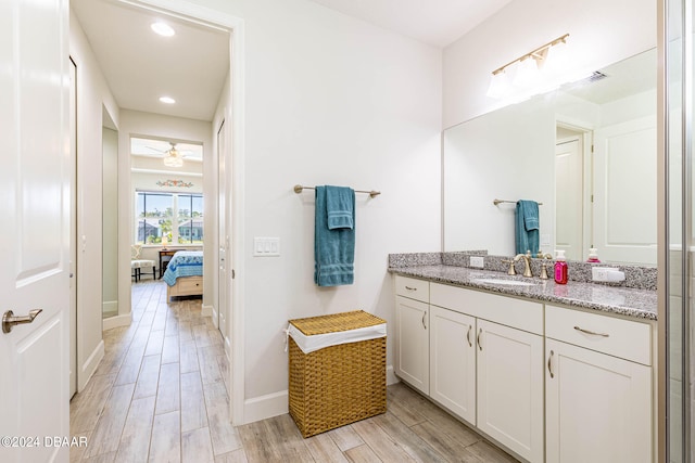 bathroom with vanity, hardwood / wood-style flooring, and ceiling fan