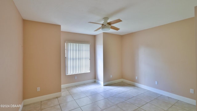 tiled spare room with ceiling fan