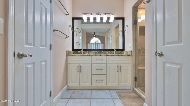 bathroom featuring tile patterned floors, vanity, and walk in shower