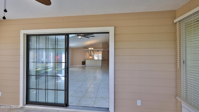 property entrance with ceiling fan