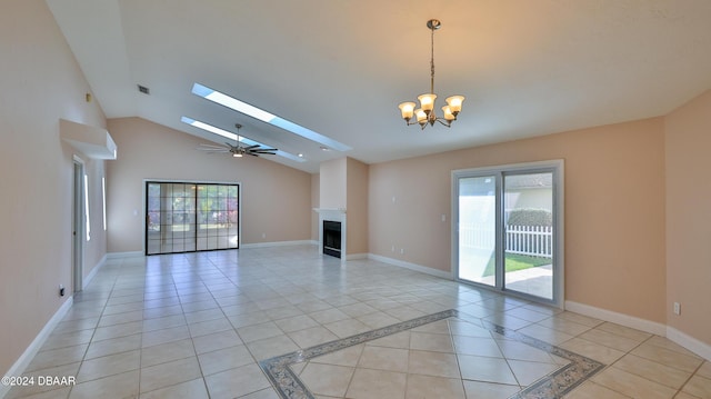 unfurnished living room featuring a wealth of natural light, light tile patterned floors, ceiling fan with notable chandelier, and lofted ceiling