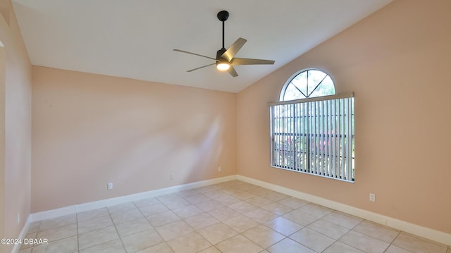 tiled spare room featuring ceiling fan and lofted ceiling