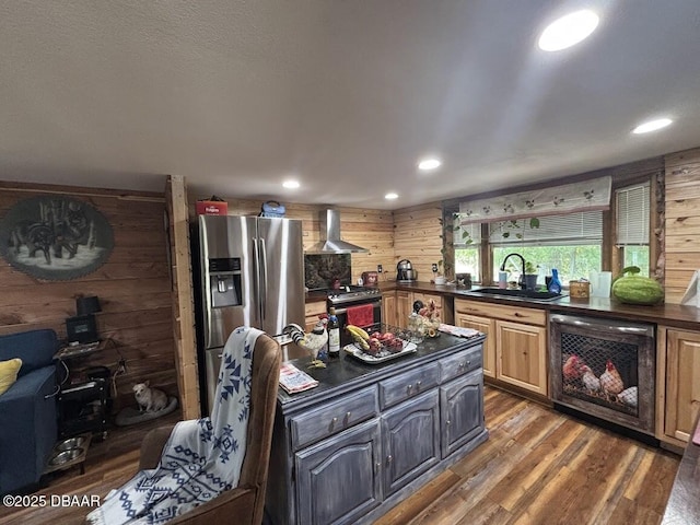 17531 NE 139th Ave, Fort Mccoy, FL 32134 - kitchen with wall chimney range hood, dark countertops, appliances with stainless steel finishes, wood walls, and wood finished floors