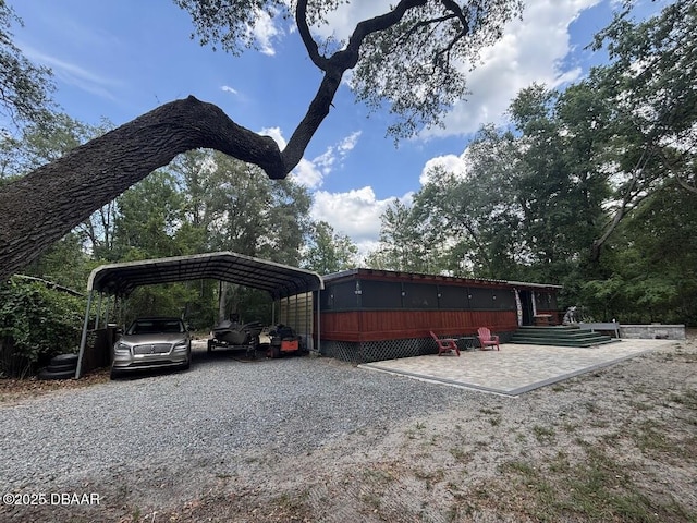 17531 NE 139th Ave, Fort Mccoy, FL 32134 - view of parking with a carport and gravel driveway