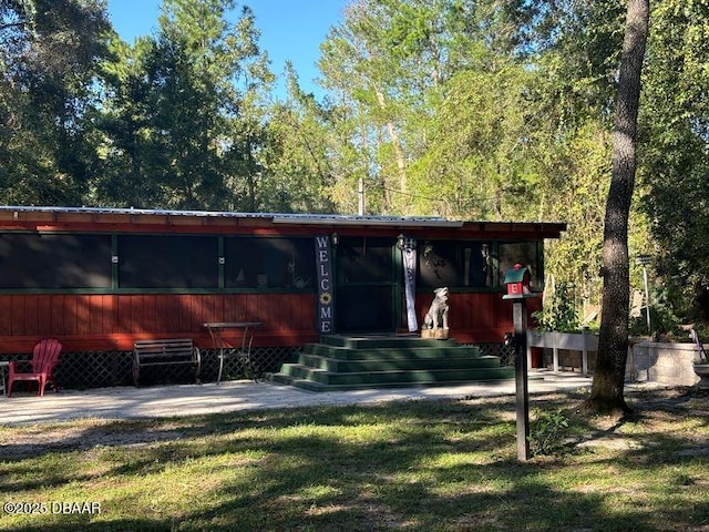 17531 NE 139th Ave, Fort Mccoy, FL 32134 - rear view of property with a metal roof and a yard