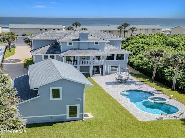 back of house with a water view, a balcony, a yard, and a patio