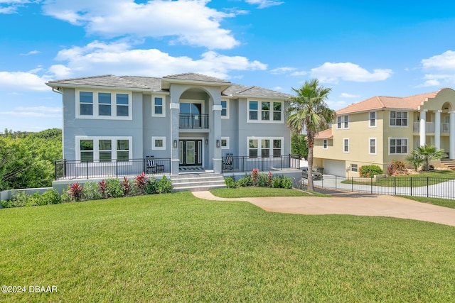 mediterranean / spanish-style home featuring a front lawn