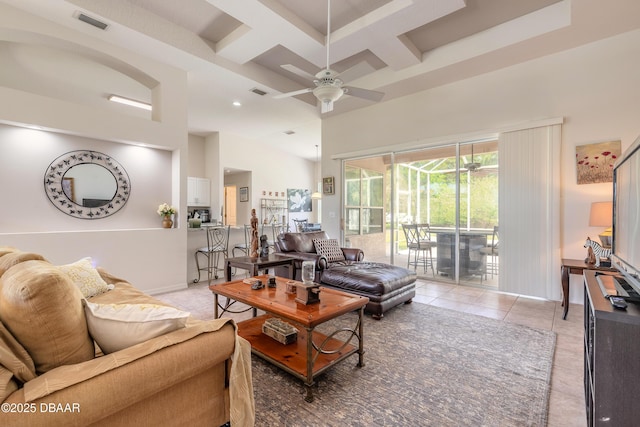 living room featuring ceiling fan, a towering ceiling, visible vents, light tile patterned flooring, and coffered ceiling