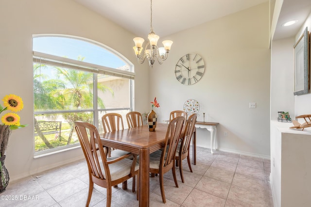dining space featuring an inviting chandelier, baseboards, and light tile patterned floors